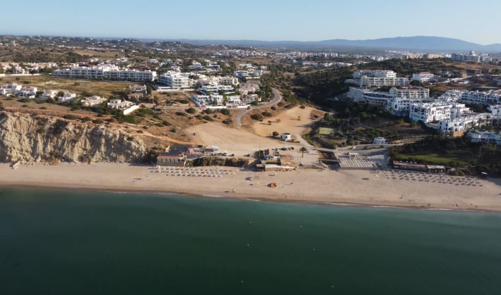 Coastal landscape showing a beachfront with residential buildings