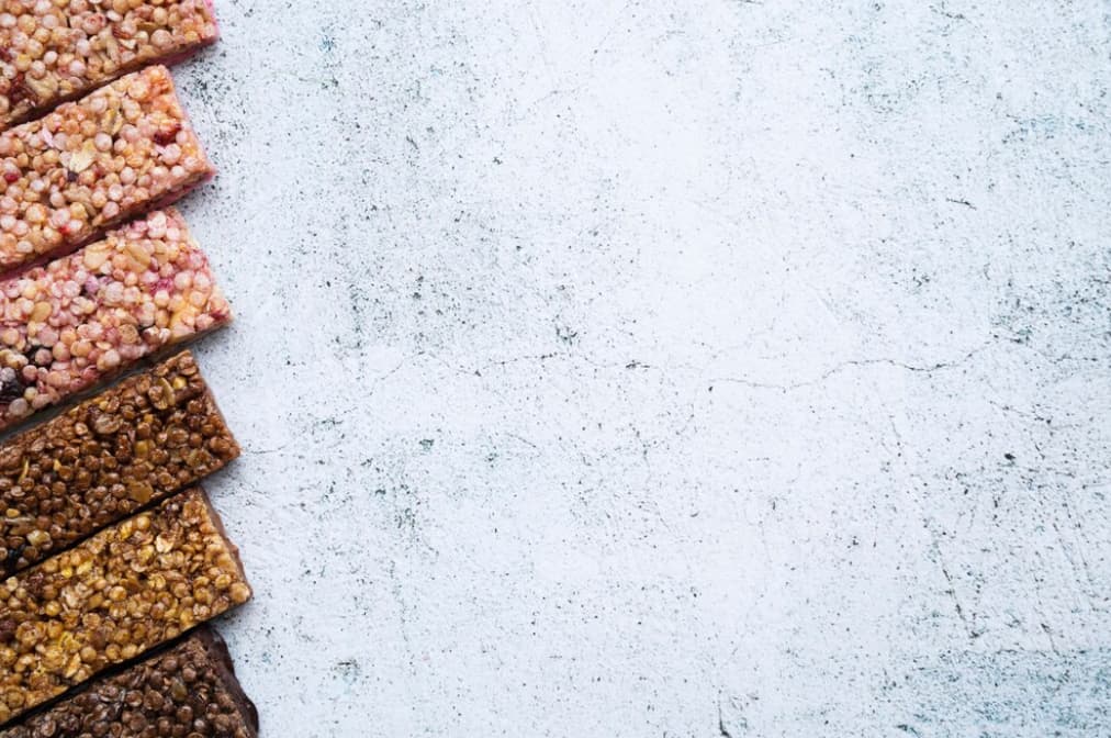 Assorted grain bars on a textured white surface